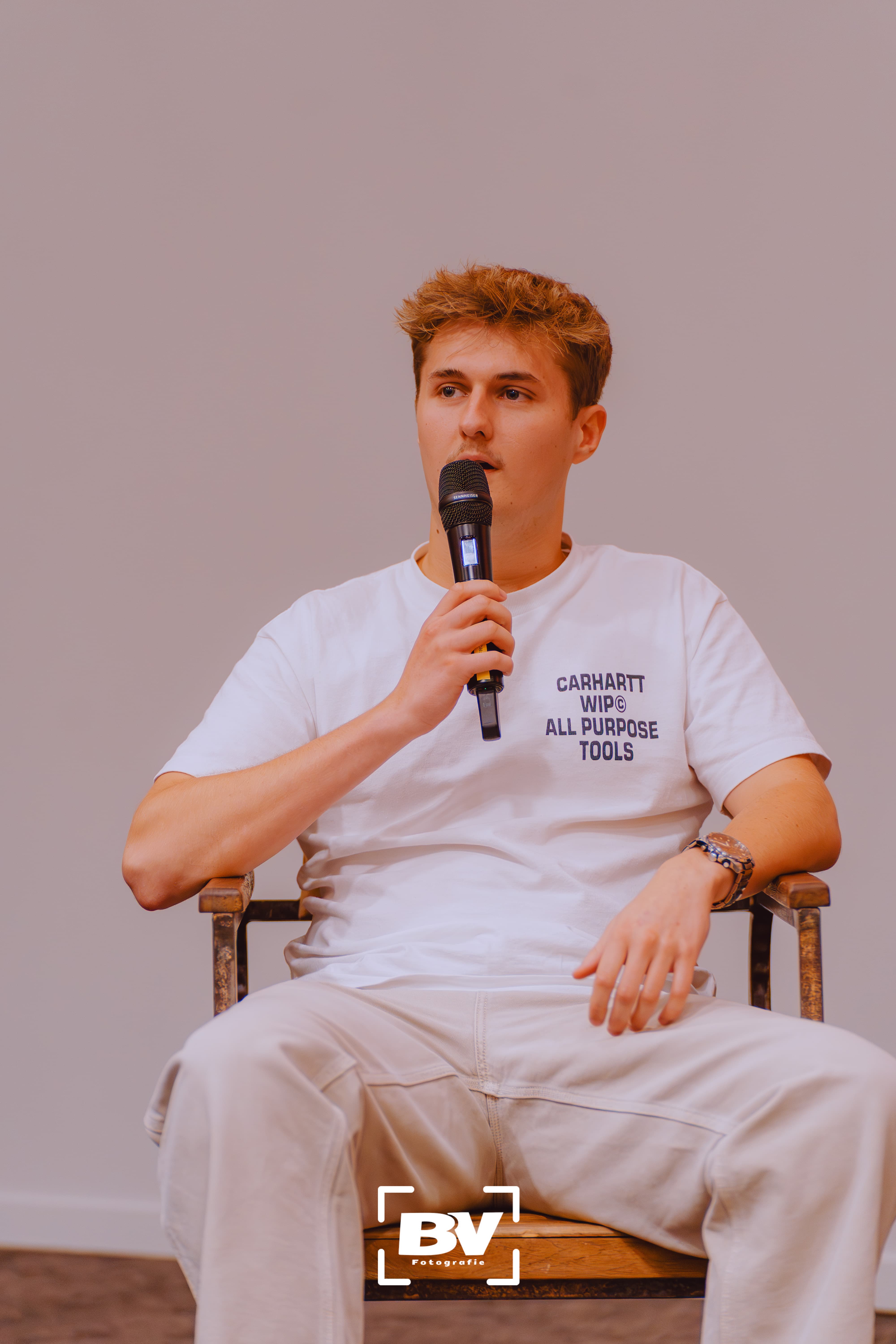 Brent speaking into a microphone